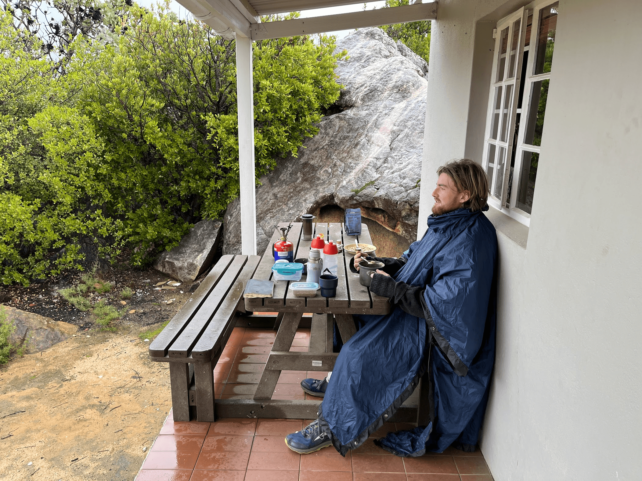 David with his prized (stolen) spoon stares out into the rain.